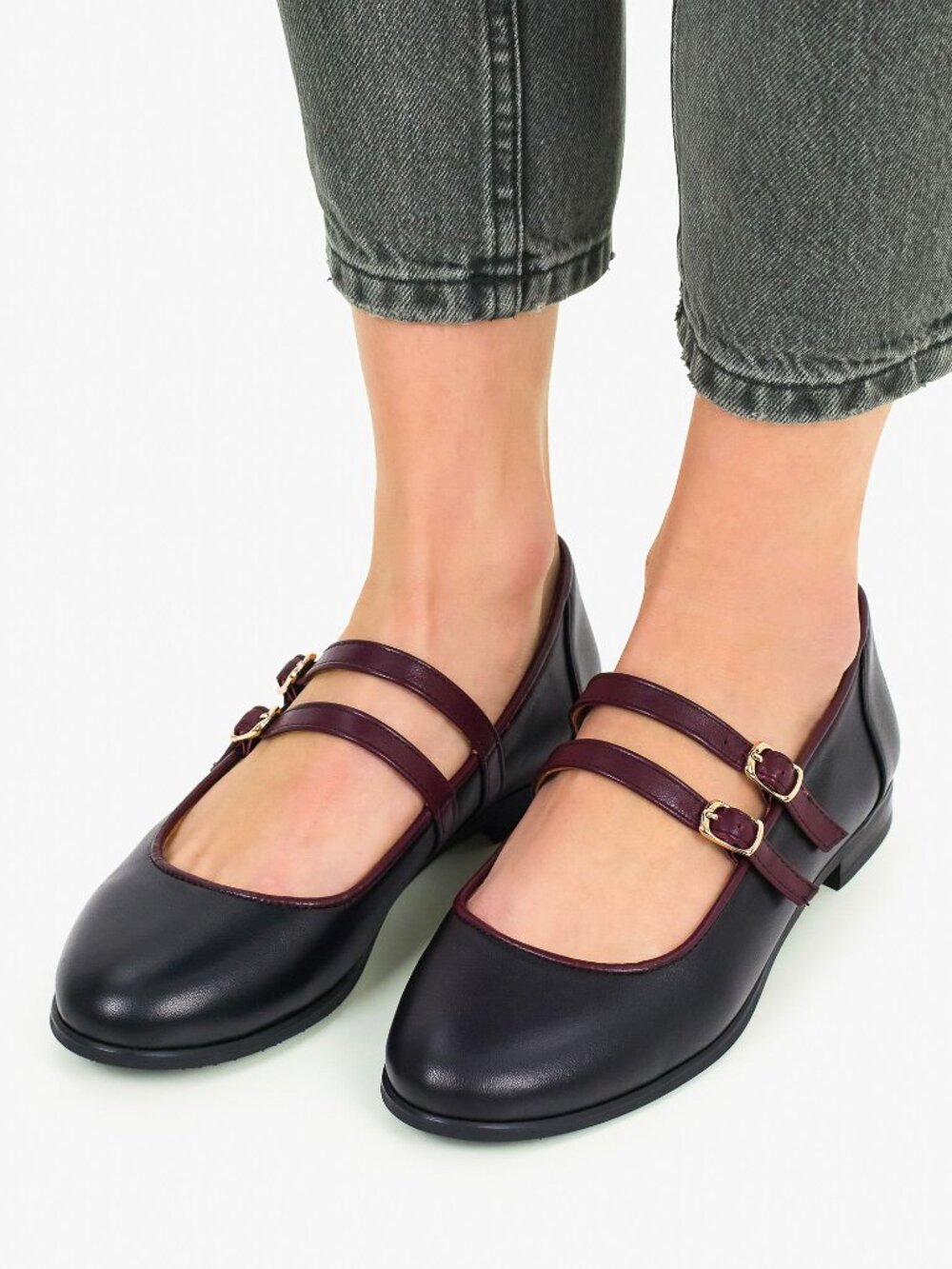 Women's black leather ballet flats with burgundy straps